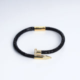 Wrap Soudage Black & Gold textured leather bracelet with gold nail clasp, viewed from above